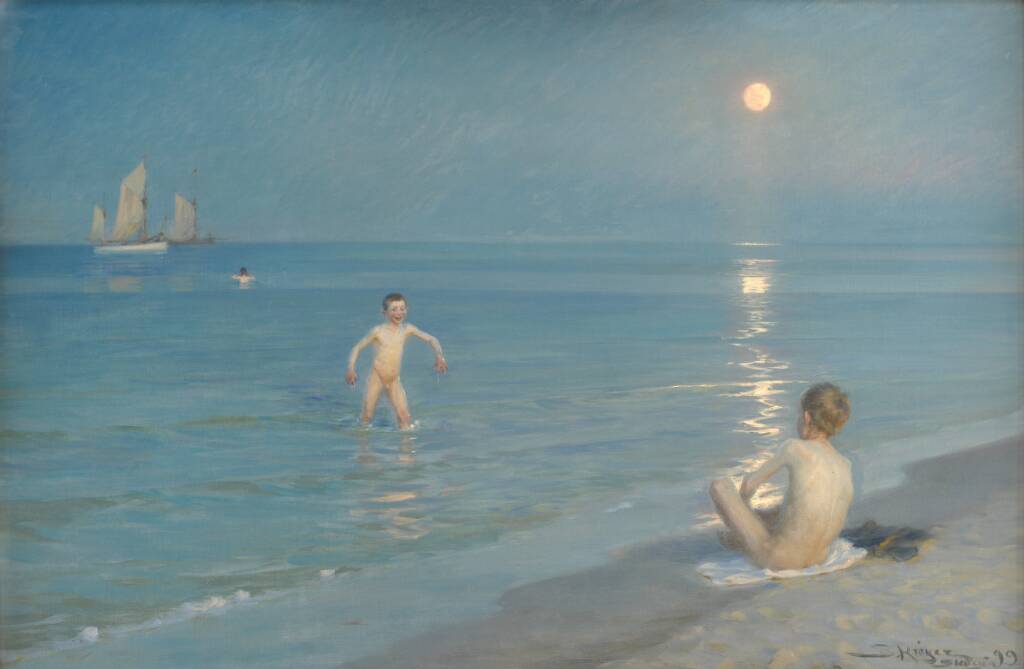Two children play in the shallow water at the beach under a bright, full moon. One child sits on the sand while the other stands in the water. A sailboat floats in the distance on the calm sea.