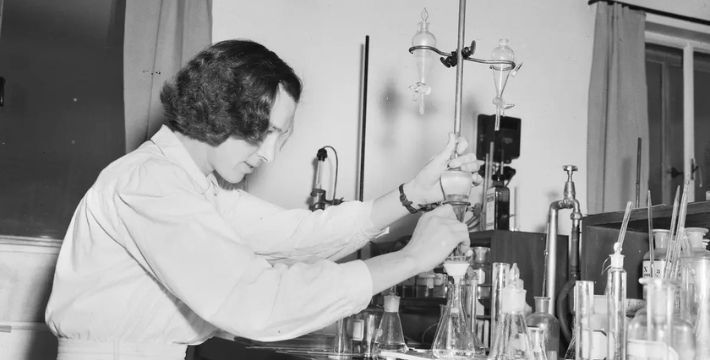 A black and white photo of a scientist in a lab