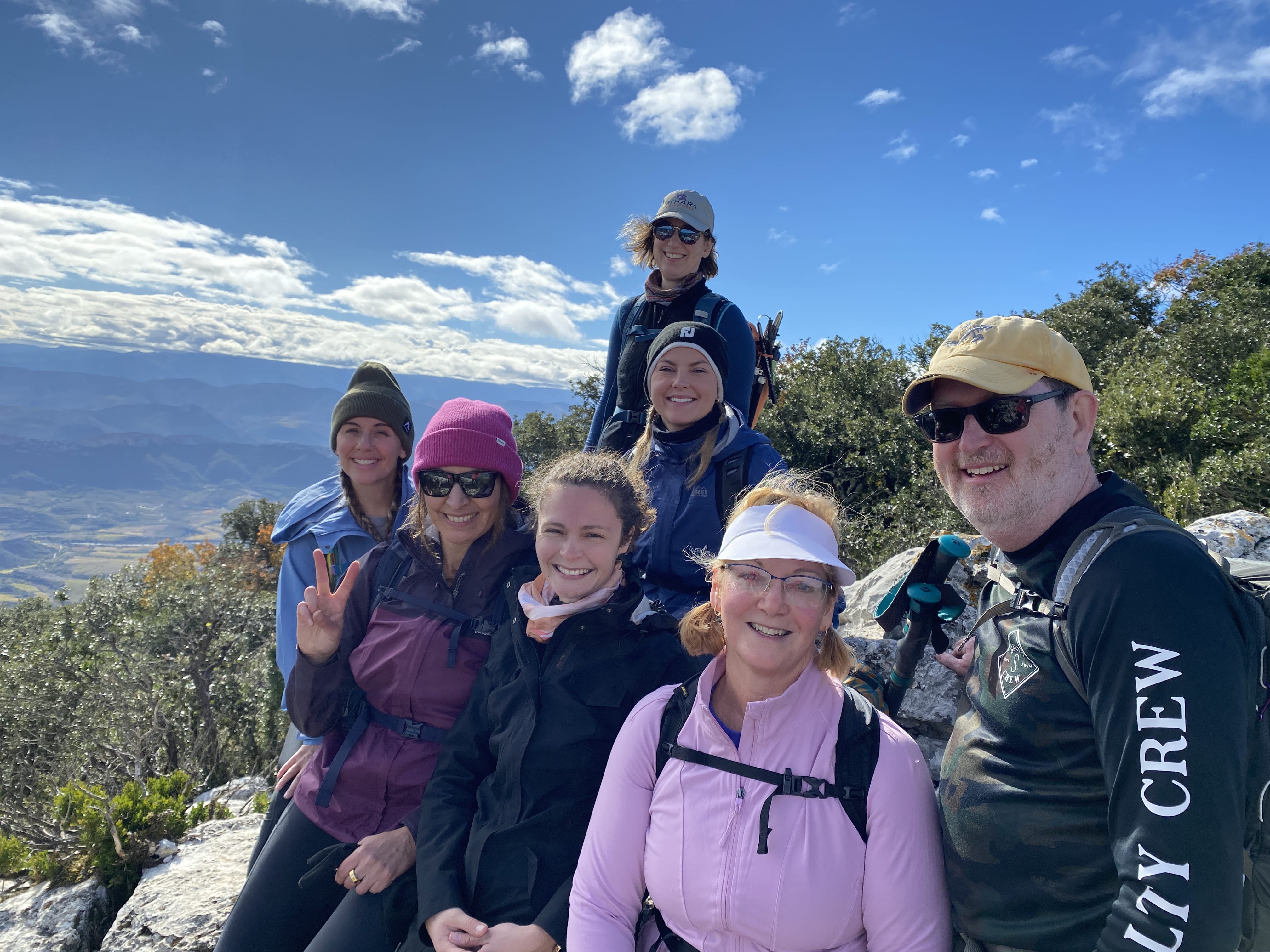 Ridges and Valleys tour participants on the top of a mountain smiling with a blue sky in southern France.
