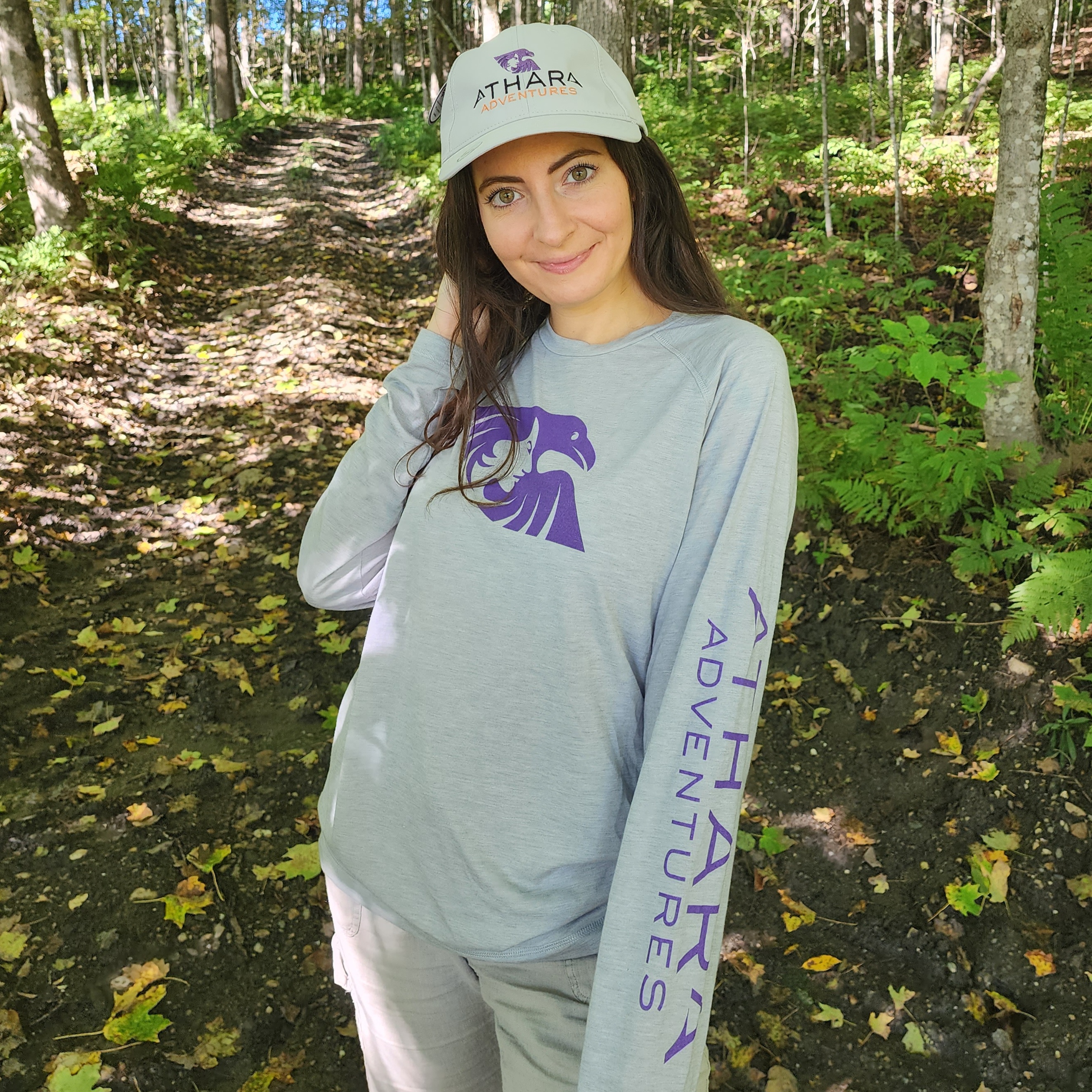 Woman wearing an Athara Adventures hat and sweatshirt.