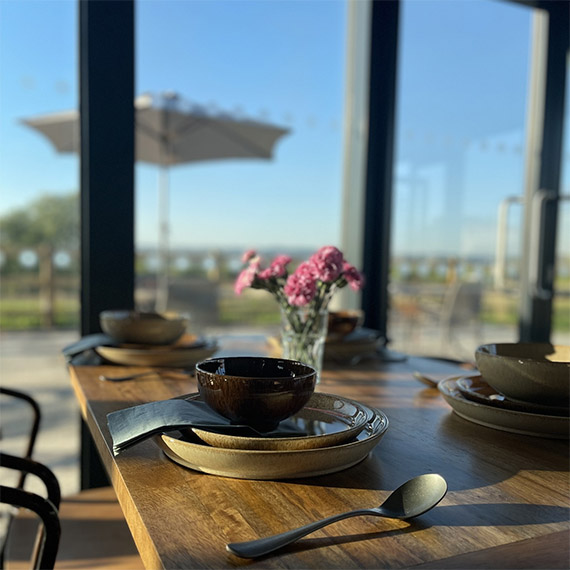 A table in our cafe with bright windows and stunning vistas