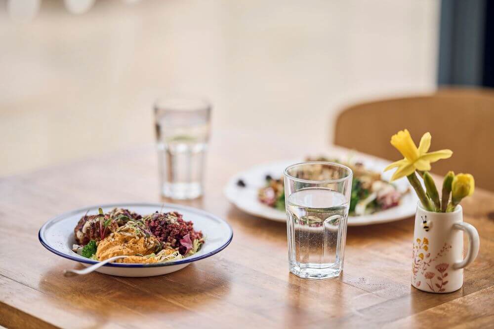 A table in our cafe with bright windows and stunning vistas
