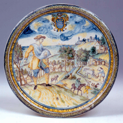 A decorative plate depicting a man surrounded by a rural landscape