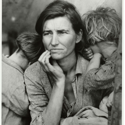 A black and white photo depicting a woman with two children